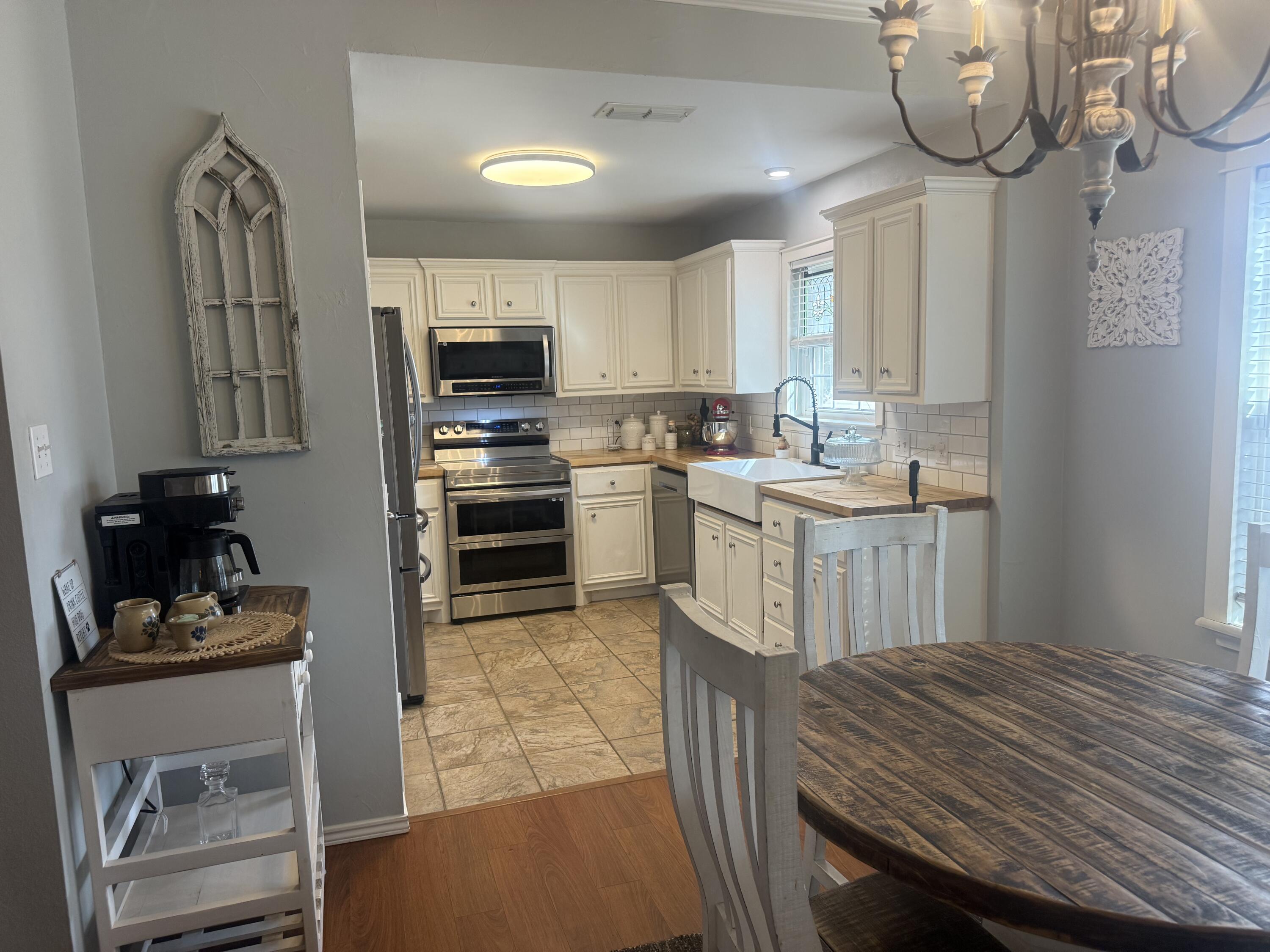 6906 8th Street Lubbock, TX 79416 - Photo 11 of 42 a kitchen with a stove a refrigerator and cabinets