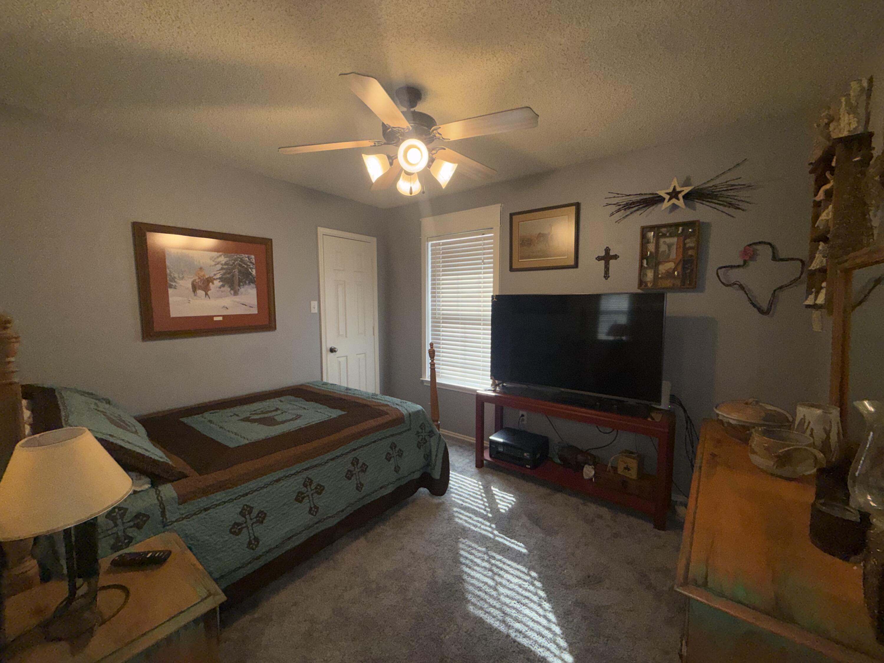 6906 8th Street Lubbock, TX 79416 - Photo 26 of 42 a living room with furniture and a flat screen tv