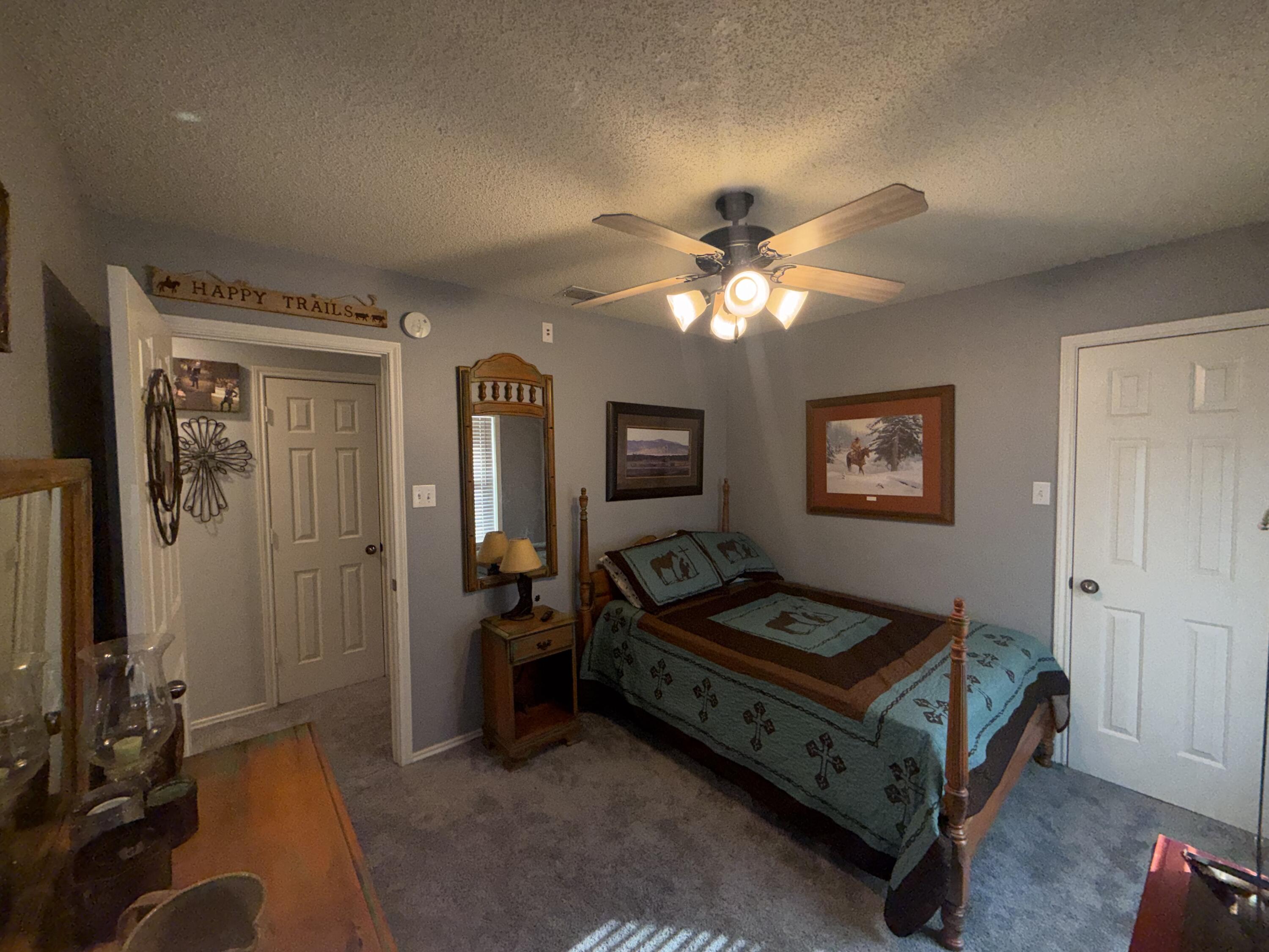 6906 8th Street Lubbock, TX 79416 - Photo 27 of 42 a living room with furniture and a chandelier