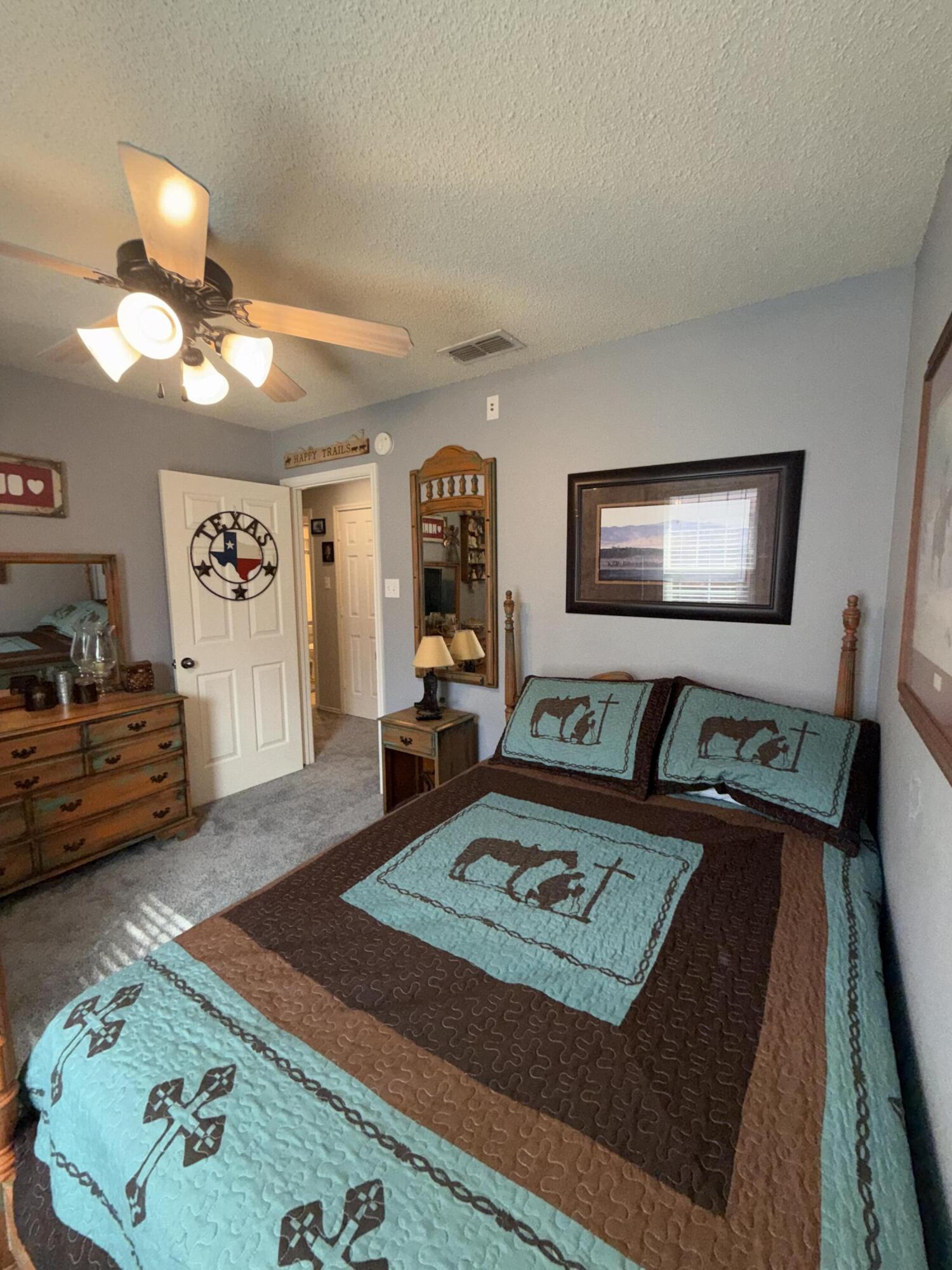 6906 8th Street Lubbock, TX 79416 - Photo 28 of 42 a living room with furniture and a flat screen tv