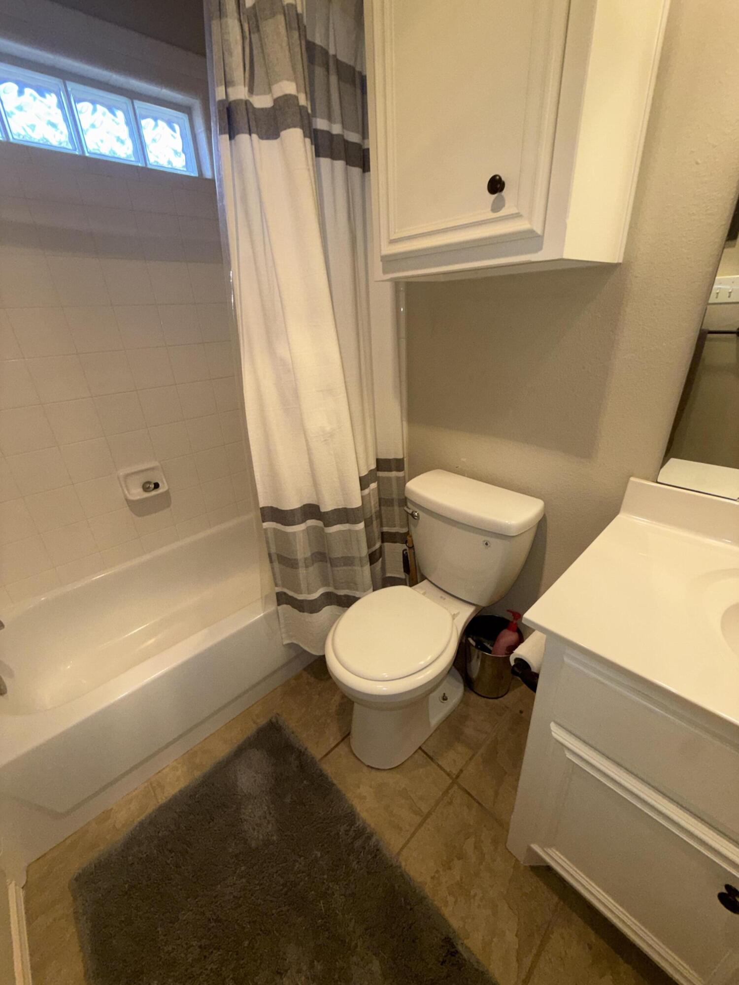 6906 8th Street Lubbock, TX 79416 - Photo 31 of 42 a white toilet sitting next to a bath tub