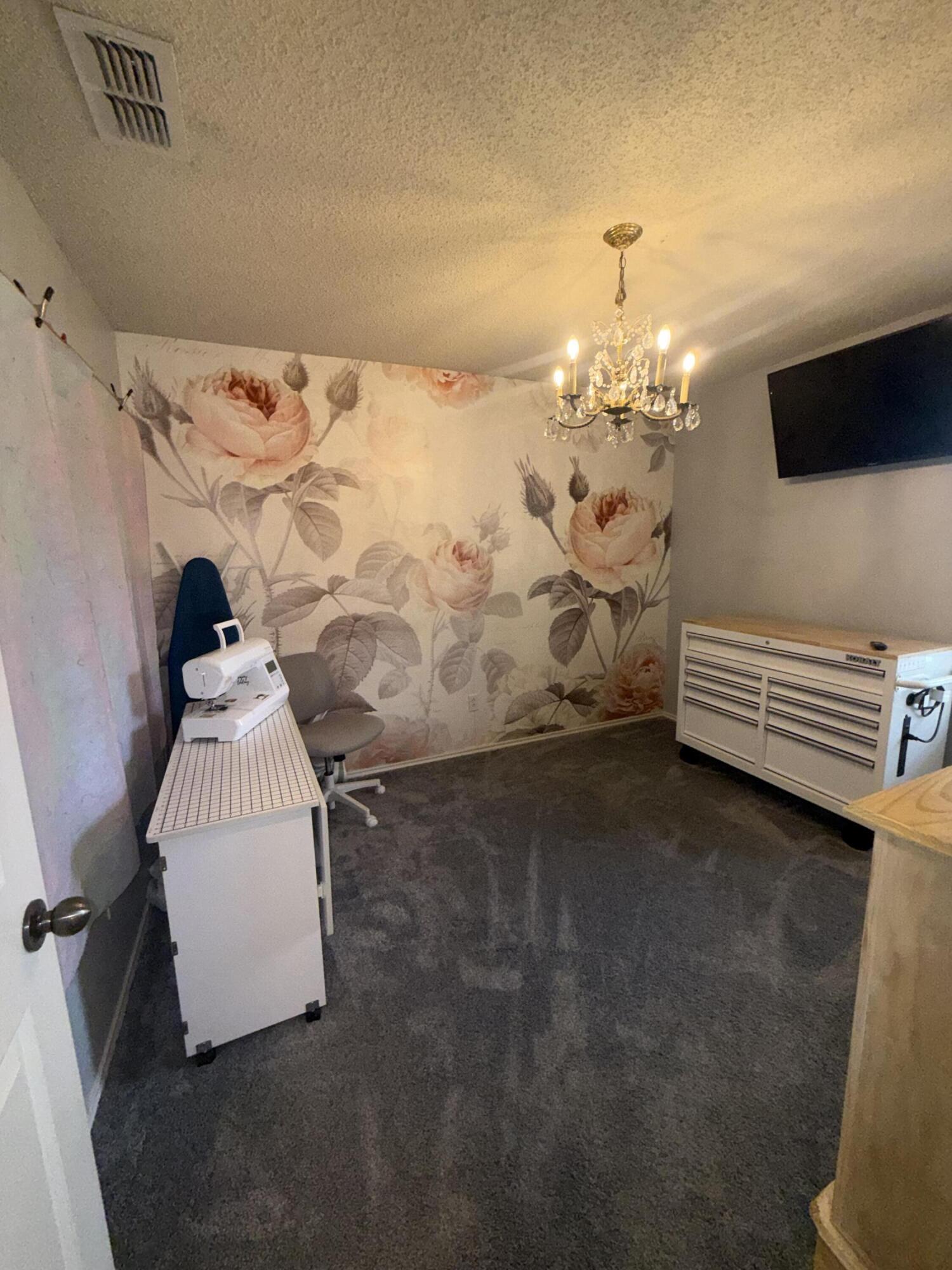 6906 8th Street Lubbock, TX 79416 - Photo 34 of 42 a room with a bed and a flat screen tv