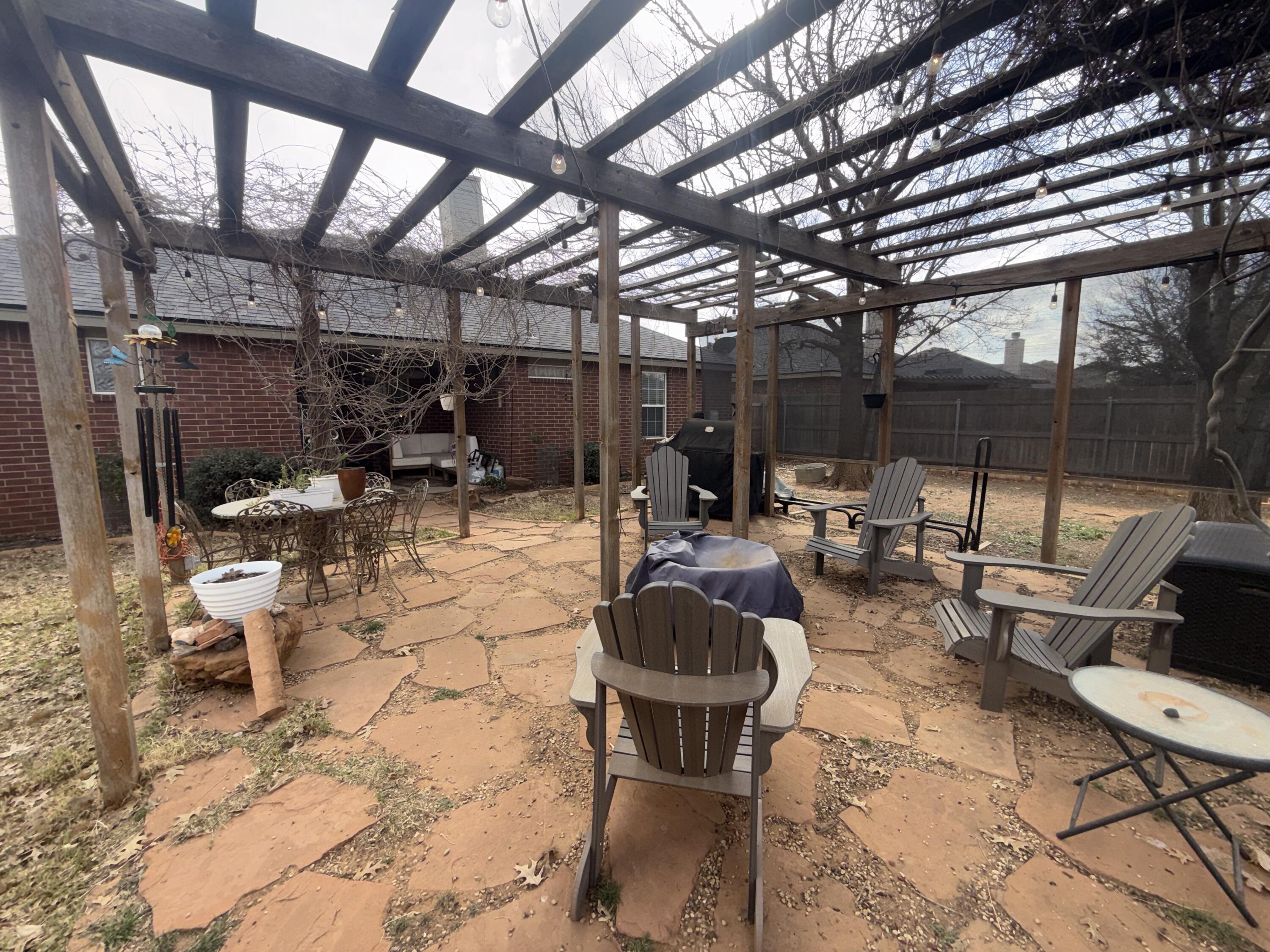 6906 8th Street Lubbock, TX 79416 - Photo 41 of 42 a outdoor space with lots of white furniture and shower