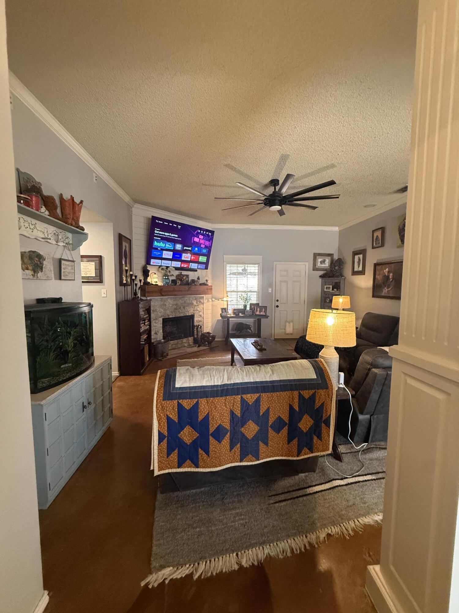 6906 8th Street Lubbock, TX 79416 - Photo 5 of 42 a living room with furniture and a flat screen tv