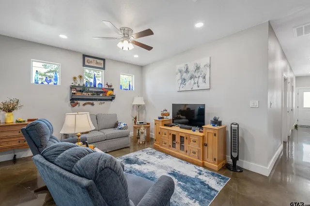 a living room with furniture a fireplace and a flat screen tv