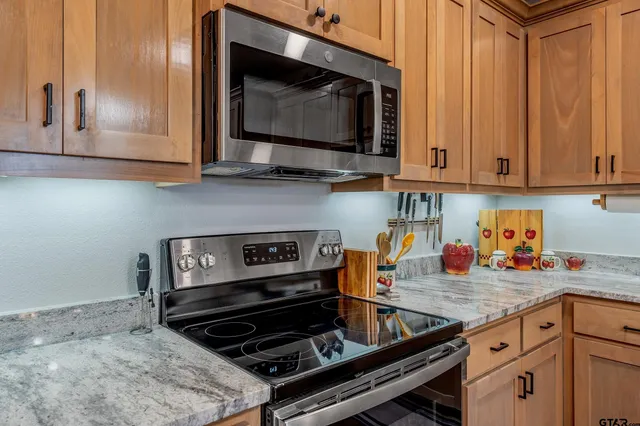 a kitchen with wooden cabinets and a stove top oven