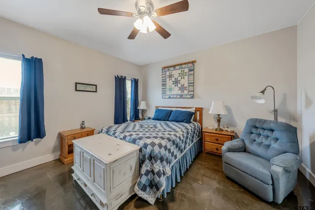 a bedroom with a bed couch and a window