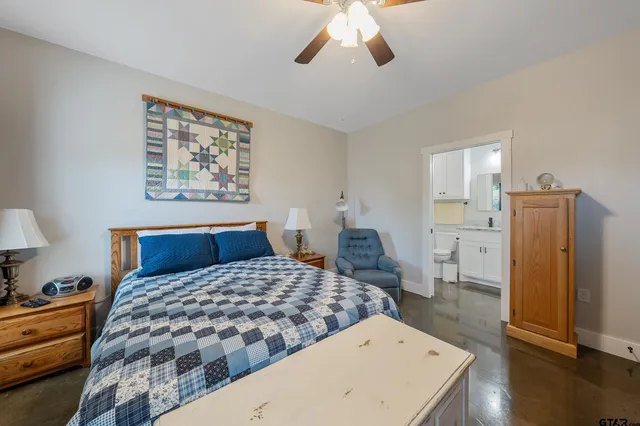 a bedroom with a large bed and a chandelier