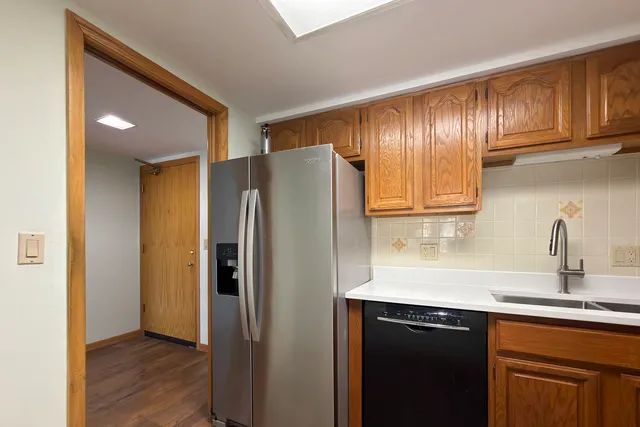 a kitchen with stainless steel appliances granite countertop a refrigerator and a sink