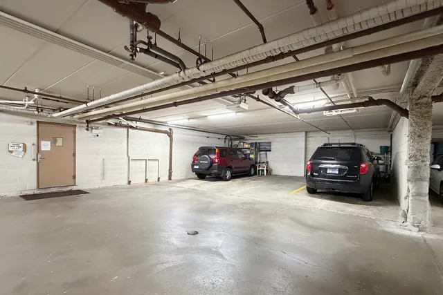a view of parking garage with cars parked
