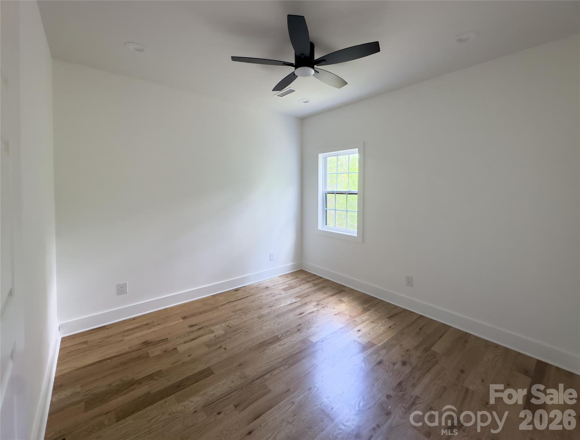 6265 Riviera Run Estates Drive Hickory, NC 28601 - Photo 25 of 44 a view of an empty room with a window and wooden floor