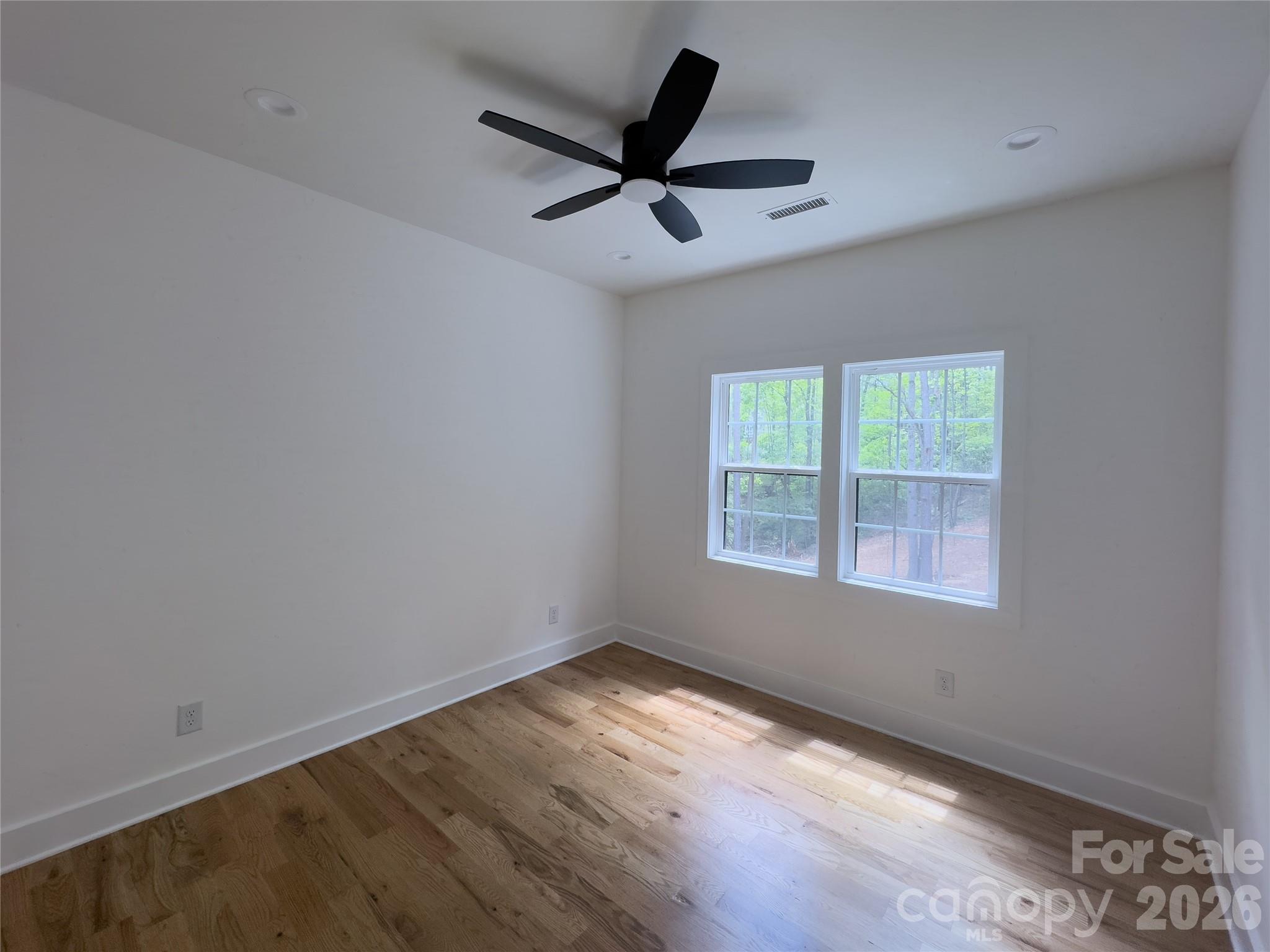 6265 Riviera Run Estates Drive Hickory, NC 28601 - Photo 28 of 44 wooden floor in an empty room with a window
