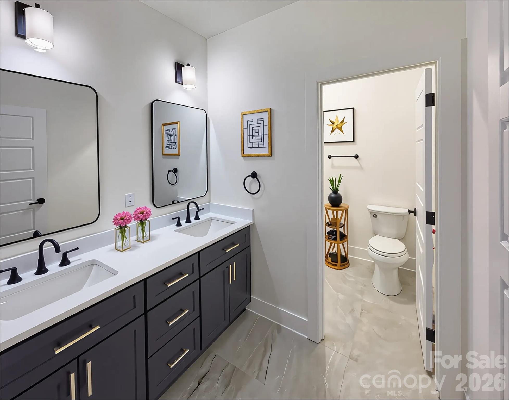6265 Riviera Run Estates Drive Hickory, NC 28601 - Photo 29 of 44 a spacious bathroom with a double vanity sink toilet and a mirror