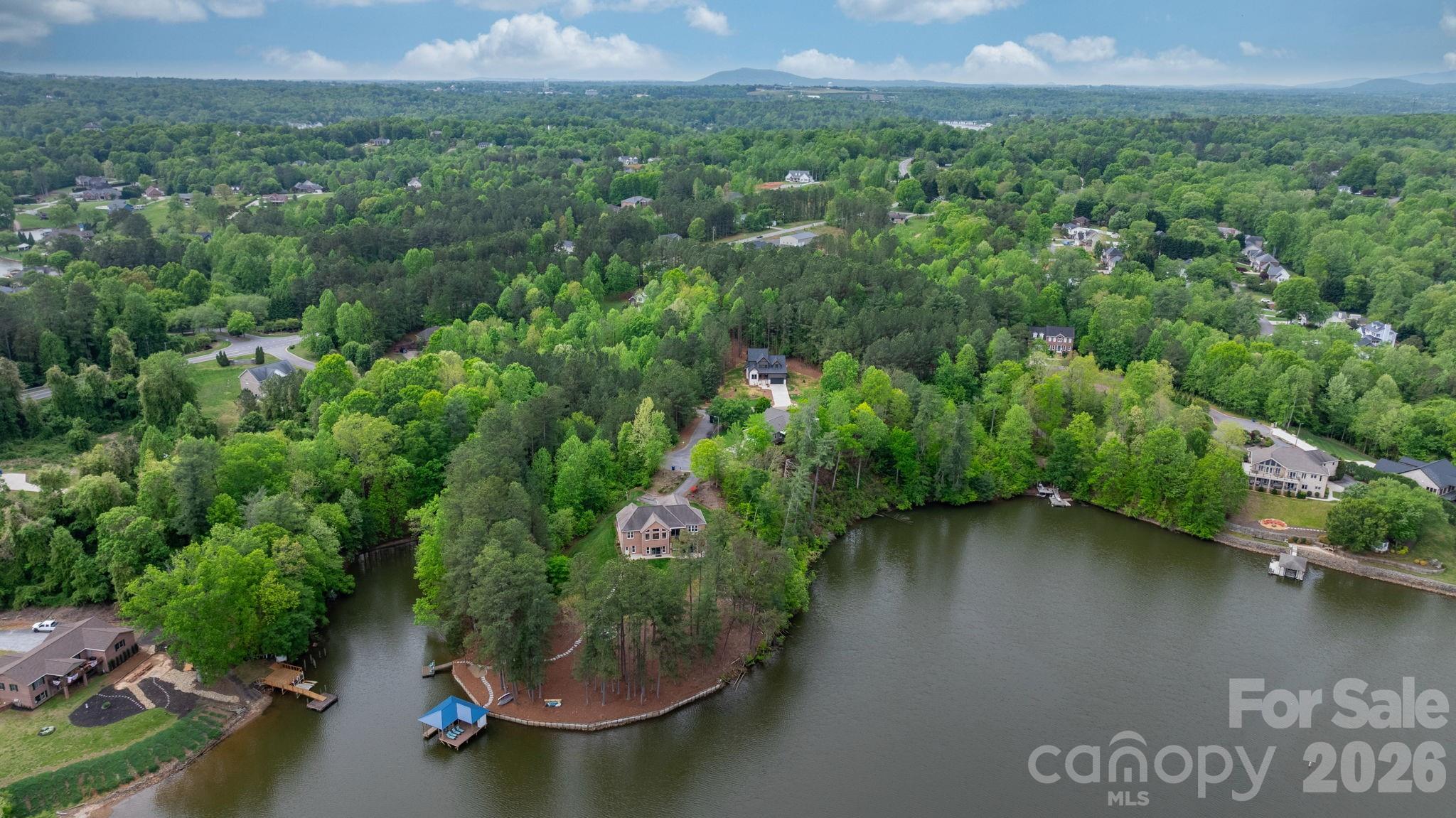 6265 Riviera Run Estates Drive Hickory, NC 28601 - Photo 40 of 44 an aerial view of a house with a yard and lake view