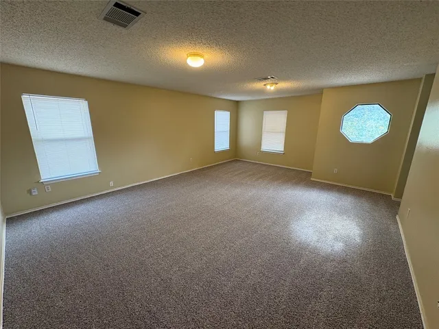 a view of washer and dryer with bathtub in a bathroom