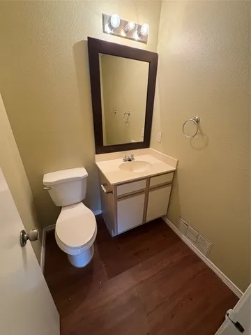 a bathroom with a toilet a sink and mirror