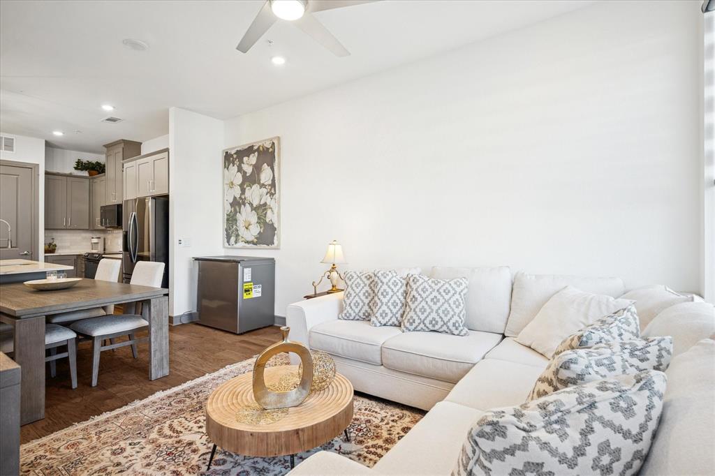2700 Old Denton Road, Unit 3346 Carrollton, TX 75007 - Photo 11 of 21 a living room with furniture a rug and kitchen view