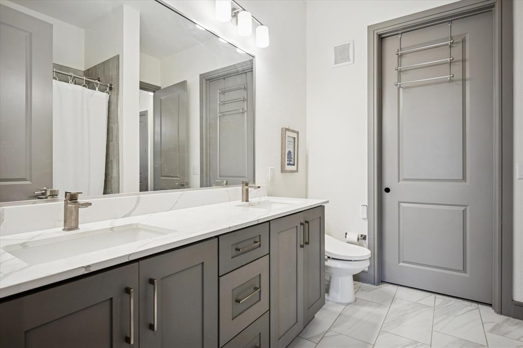 2700 Old Denton Road, Unit 3346 Carrollton, TX 75007 - Photo 13 of 21 a bathroom with a granite countertop sink toilet and mirror