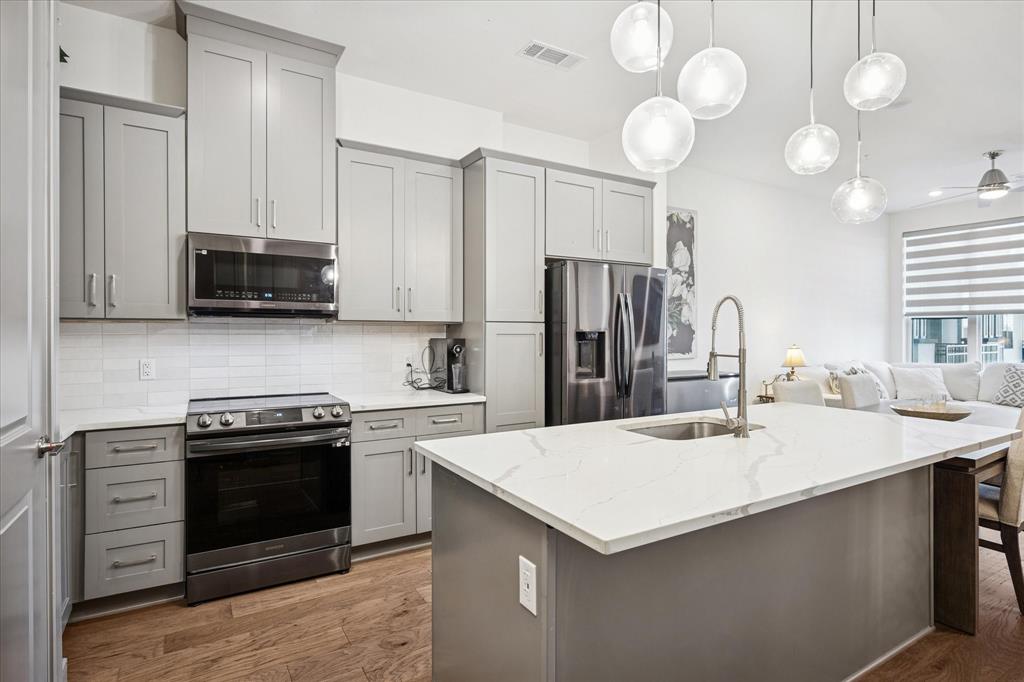2700 Old Denton Road, Unit 3346 Carrollton, TX 75007 - Photo 2 of 21 a kitchen with a stove a sink and a refrigerator