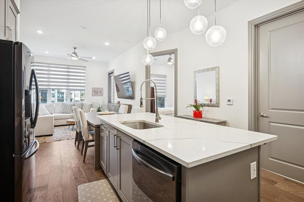 2700 Old Denton Road, Unit 3346 Carrollton, TX 75007 - Photo 7 of 21 a kitchen with a stove a sink a dining table and chairs