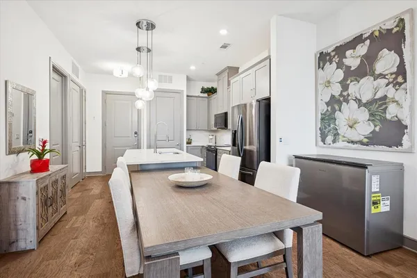 a large kitchen with a table and chairs