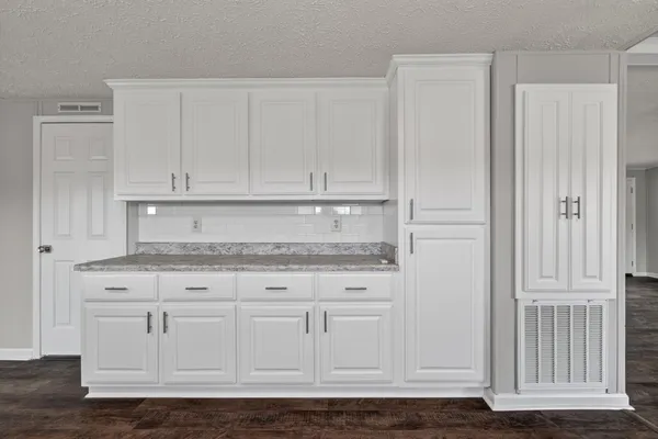a stove top oven sitting inside of a kitchen