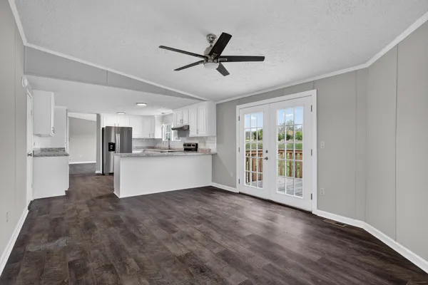 a view of open kitchen with wooden floor and window