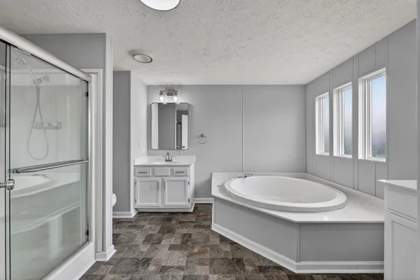 a bathroom with a bathtub and a sink