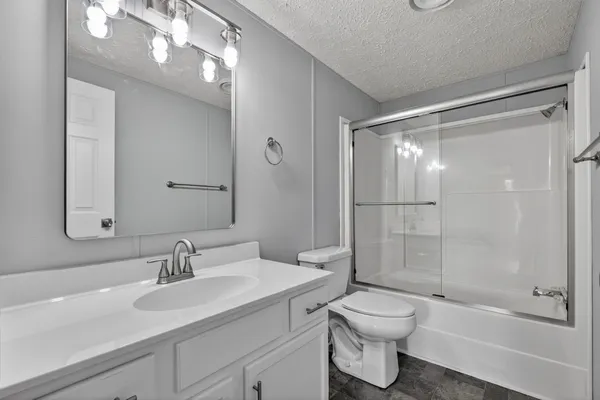 a bathroom with a toilet sink and shower