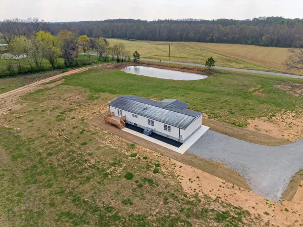 a view of a lake with a yard and a mountain view