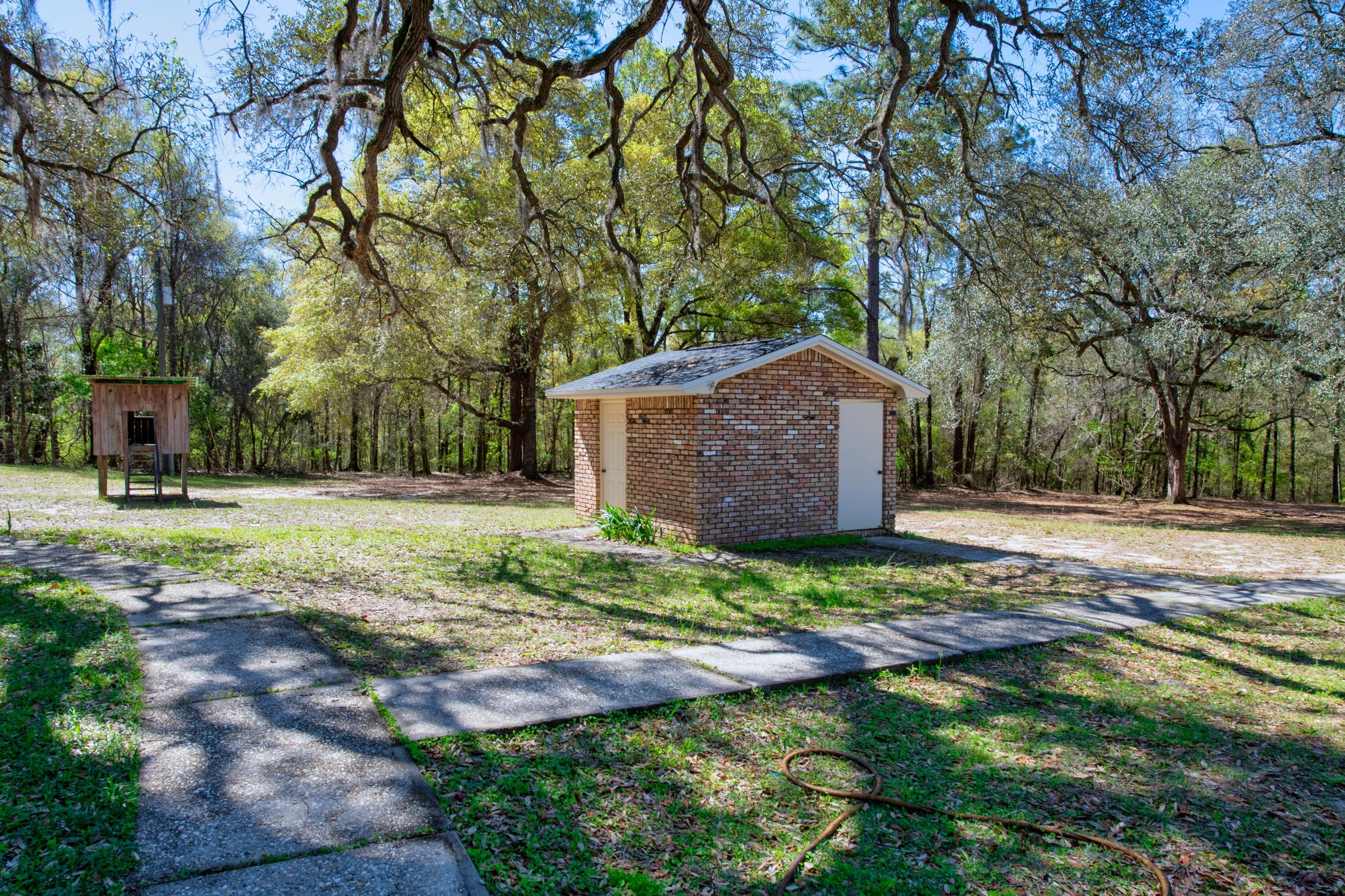 1 Lindley Road Crestview, FL 32536 - Photo 50 of 80 a backyard of a house with lots of green space