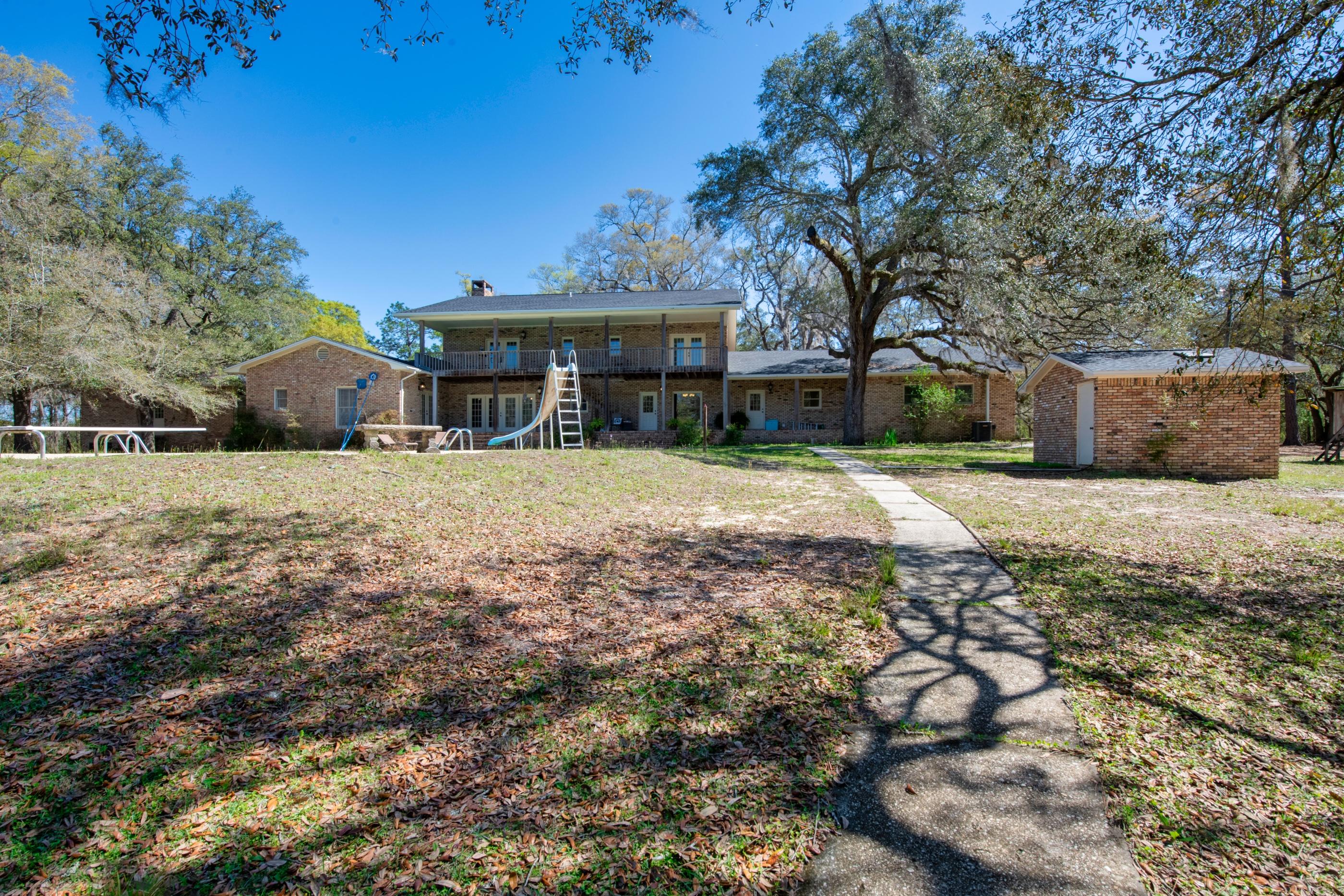 1 Lindley Road Crestview, FL 32536 - Photo 52 of 80 a front view of a house with a yard covered with trees
