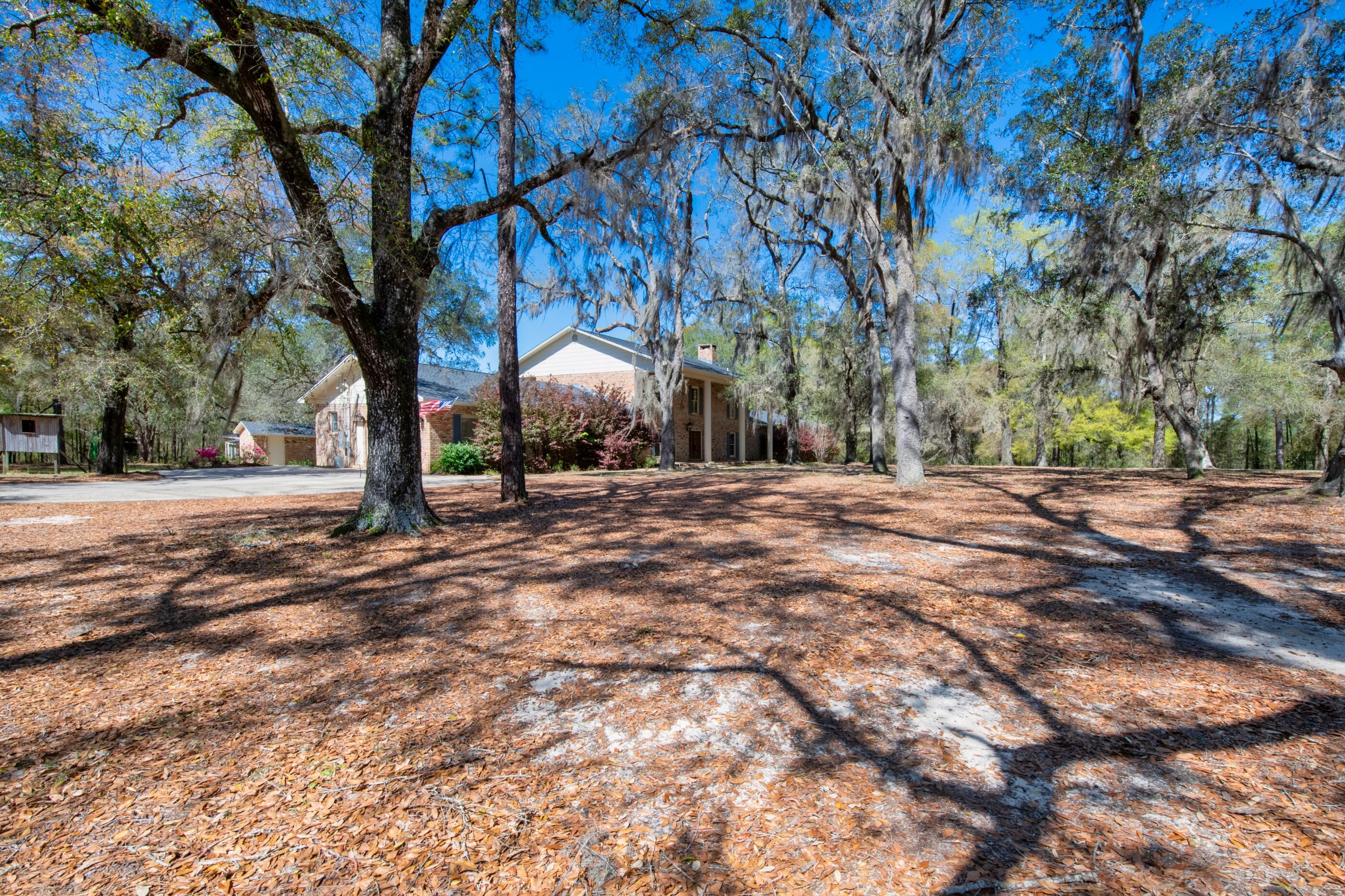 1 Lindley Road Crestview, FL 32536 - Photo 70 of 80 a backyard of a house with large trees