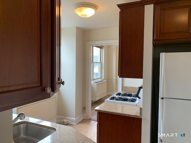 50 Glenbrook Road, Unit 5G Stamford, CT 06902 - Photo 16 of 40 a kitchen with a refrigerator and a sink