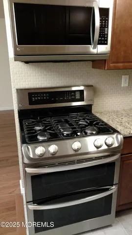 a stove top oven sitting inside of a kitchen