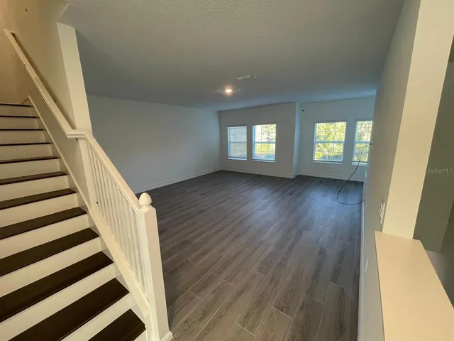 a view of entryway with wooden floor and stairs