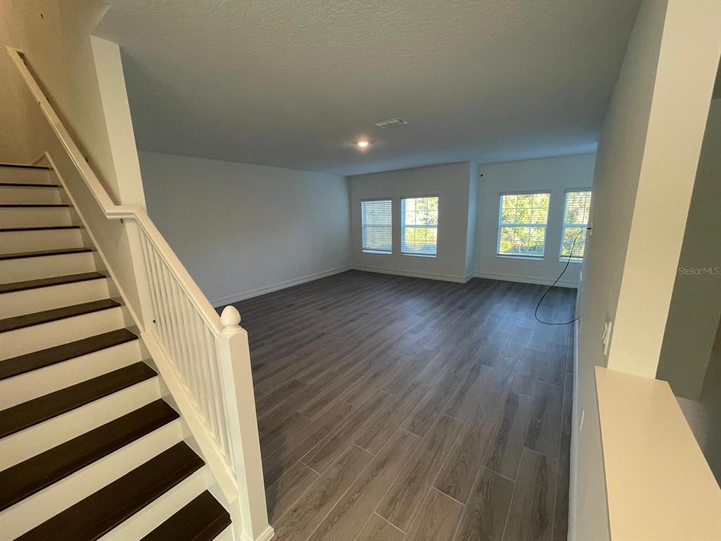 3477 Wildflower Vly Lane Wesley Chapel, FL 33543 - Photo 14 of 38 a view of entryway with wooden floor and stairs