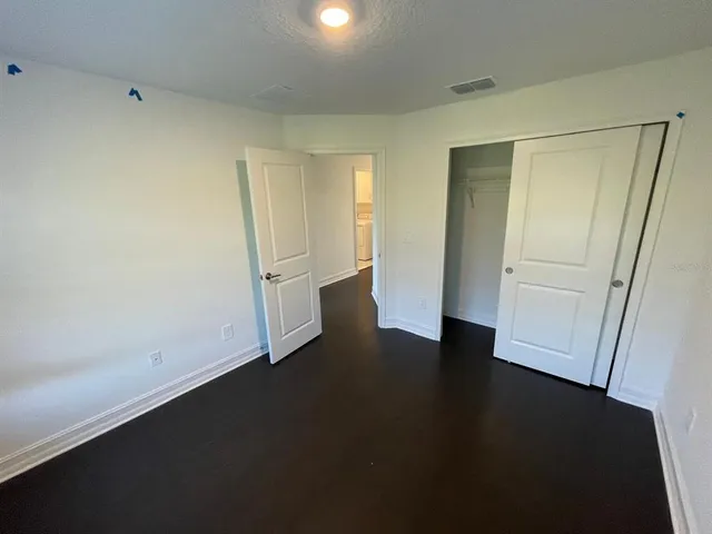 an empty room with wooden floor