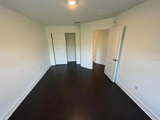 an empty room with wooden floor