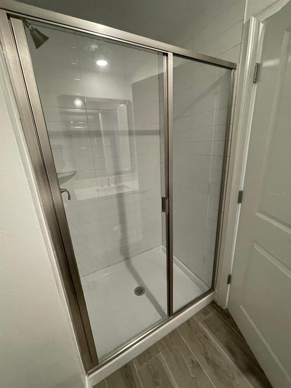 3477 Wildflower Vly Lane Wesley Chapel, FL 33543 - Photo 35 of 38 a bathroom with a glass door shower
