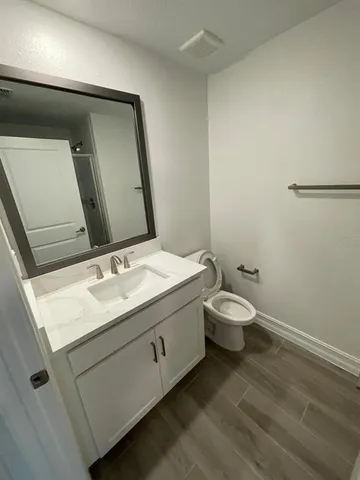 a view of a hallway with wooden floor and entryway