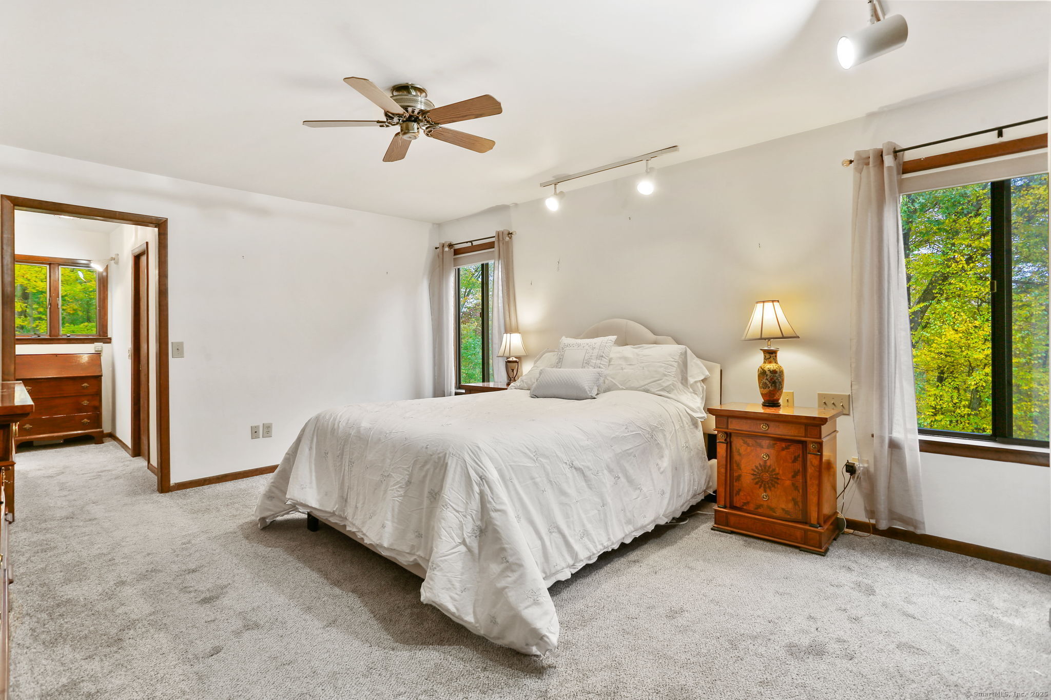 22 Ledgewood Road Redding, CT 06896 - Photo 15 of 18 a spacious bedroom with a bed and a chandelier