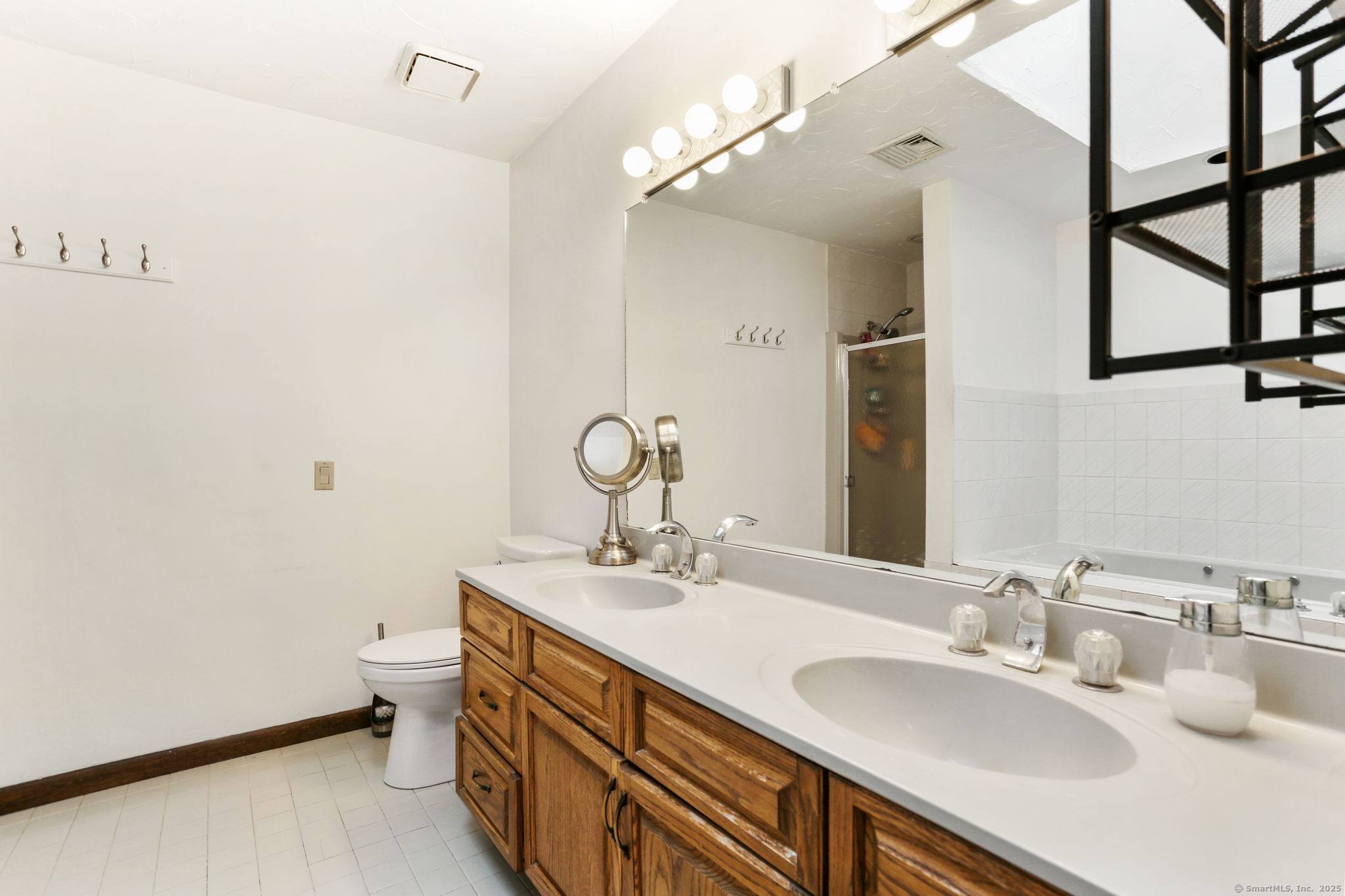 22 Ledgewood Road Redding, CT 06896 - Photo 16 of 18 a bathroom with a double vanity sink and a mirror