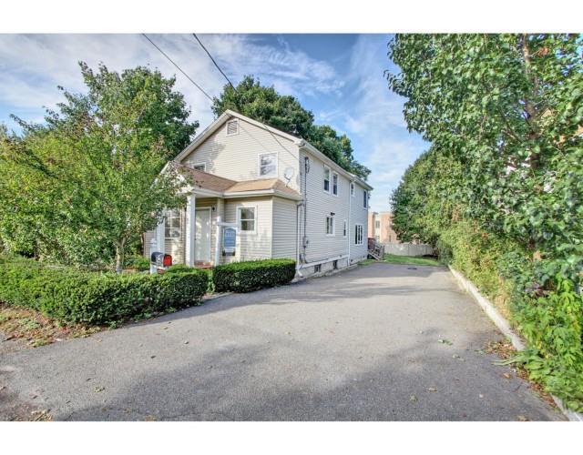 74 Rhode Island Avenue Fairfield, CT 06824 - Photo 1 of 1 a front view of a house with garden