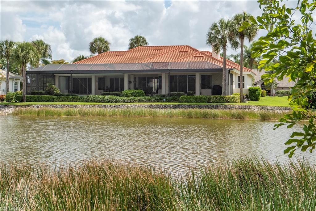 20128 Cheetah Lane Estero, FL 33928 - Photo 2 of 30 a front view of a house with a yard table and chairs