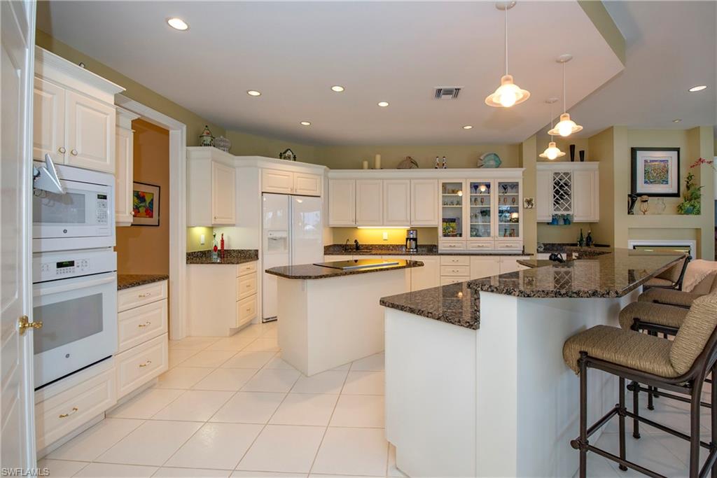 20128 Cheetah Lane Estero, FL 33928 - Photo 13 of 30 a kitchen with stainless steel appliances granite countertop a sink and cabinets