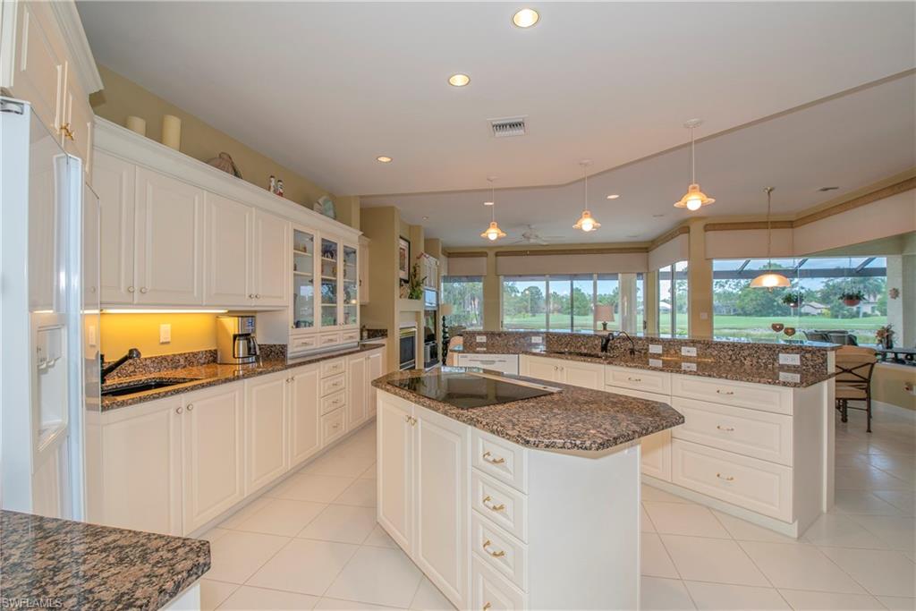 20128 Cheetah Lane Estero, FL 33928 - Photo 14 of 30 a kitchen with stainless steel appliances granite countertop a sink and a stove