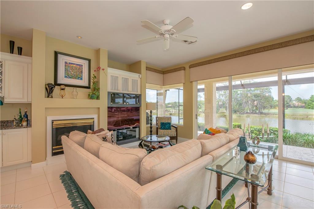 20128 Cheetah Lane Estero, FL 33928 - Photo 17 of 30 a living room with furniture a fireplace and a large window