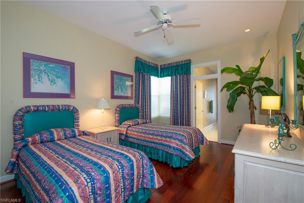 20128 Cheetah Lane Estero, FL 33928 - Photo 18 of 30 a bedroom with bed and a chandelier