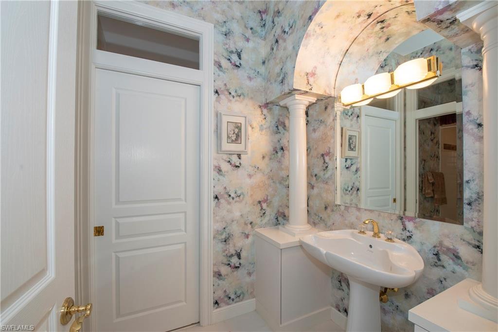 20128 Cheetah Lane Estero, FL 33928 - Photo 20 of 30 a bathroom with a sink a mirror and a shower